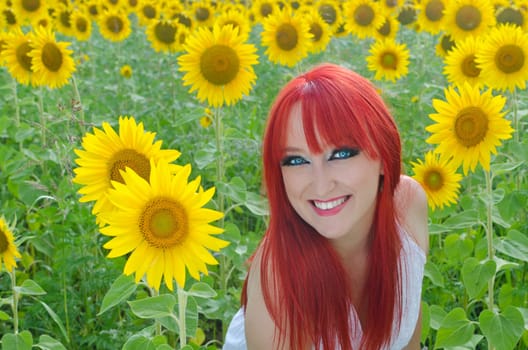 Young pretty woman on a sunflowers background