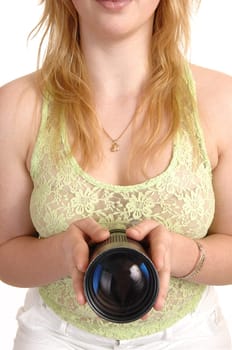 A pretty and blond girl holding a zoom lens in front of her in closeup for white background.