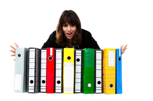Stressed female office worker with folders. Studio shot, isolated on white background