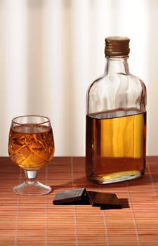 chocolate and a bottle of whiskey is on the table