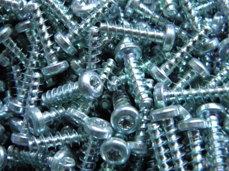 Close to recording of shiny silver steel bolts