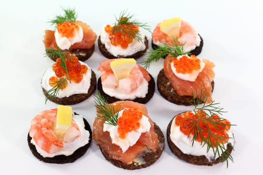 Various canapes against white background