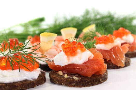 Various canapes against white background
