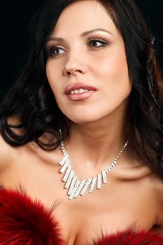 Portrait of a young attractive woman in a red fur boa.