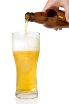 Beer pouring from bottle into glass  on white background