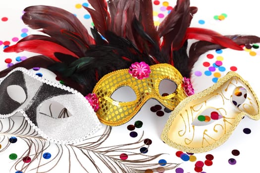 Carnival mask with confetti on white background