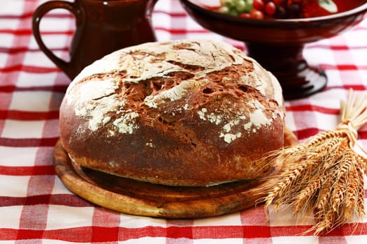 Loaf of rustic bread on black background