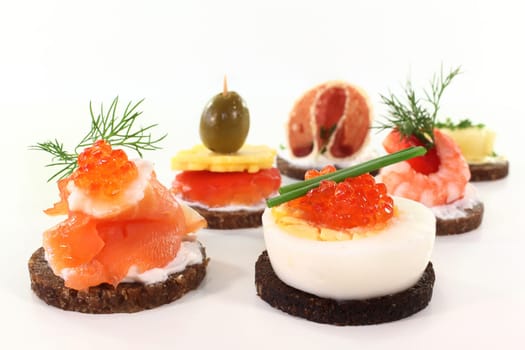 Various canapes against white background