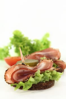 Canapes with smoked bacon and pickle