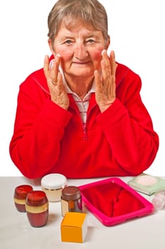 Senior woman with cosmetic products