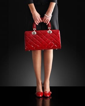 fashionable woman with a red bag, only legs