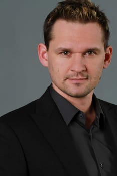 Portrait of business man in studio over grey background