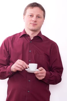 A relaxed man holding a cup of espresso