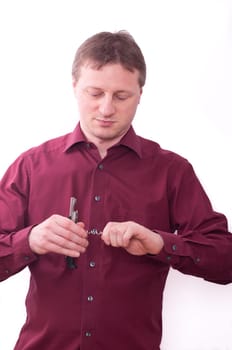 A man holds a corkscrew in his hand