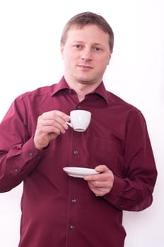 A relaxed man holding a cup of espresso