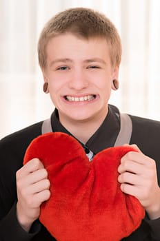 frustrated teenager  with a plush heart in hand
