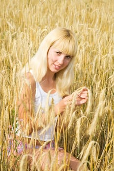 Young woman in the rye meadow