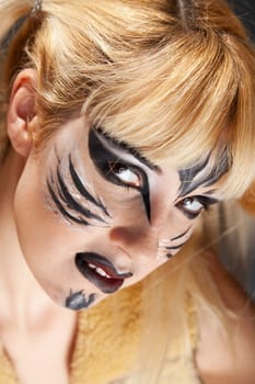 Young woman paint as the wild feline