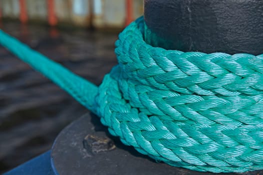 Mooring bollard with nautical rope knotted on it