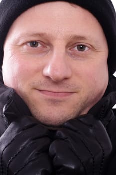 A man with a cap and gloves in the cold