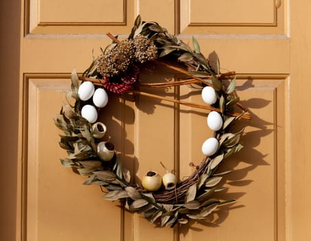 Traditional design of a christmas wreath attached to the front door of old house