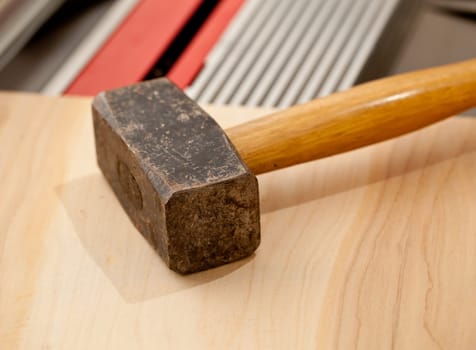 Large steel pound hammer on workbench in close up