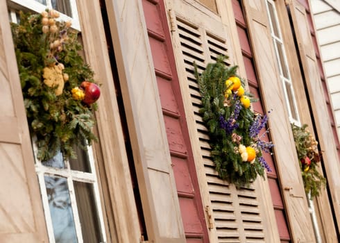 Traditional design of a christmas wreath attached to the front door of old house