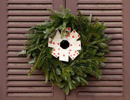 Traditional design of a christmas wreath attached to the front door of old house