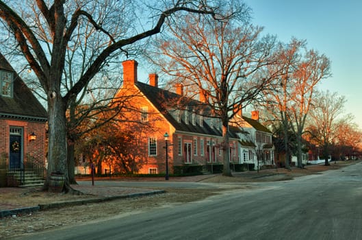 WILLIAMSBURG, VIRGINIA - DECEMBER 30: Sun rises over the restored houses on December 30, 2011. Colonial Williamsburg&#039 s 301 acres includes many restored buildings and houses