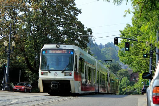 PORTLAND, OREGON - AUGUST 5: Public light rail train passing by during the day on August 5, 2010 in Portland, Oregon. There are 52.4 miles of light rail lines in the Portland metropolitan area.