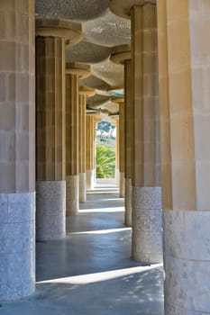 BARCELONA - JANUARY 08: Inclined Columns of the Hypostyle Hall of Park Guell on January 08, 2012 in Barcelona. Also known as Hall of 100 columns, the roof is decorated with mosaics. Built by Gaudi.
