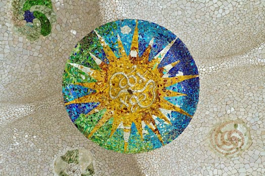Ceiling with mosaic sun at Guell Park, Barcelona, Spain.