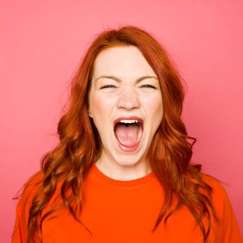 Woman with red hair on pink background