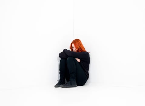 Sad woman in a white room