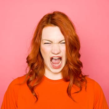 Woman with red hair on pink background