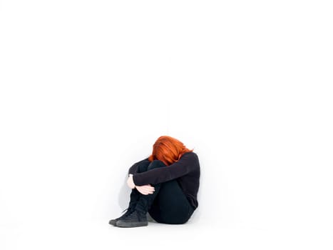 Sad woman in a white room