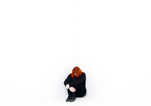 Sad woman in a white room