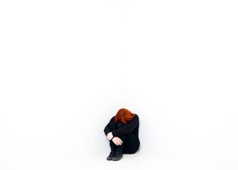 Sad woman in a white room