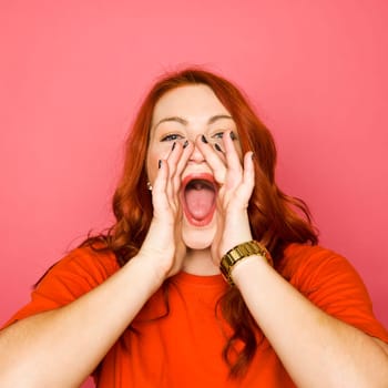 Woman with red hair on pink background