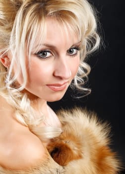 Portrait of a young attractive woman in a fox fur boa.