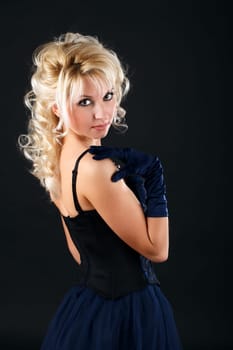 Portrait of a young attractive woman in a blue evening dress.