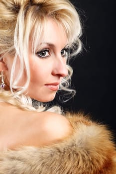Portrait of a young attractive woman in a fox fur boa.