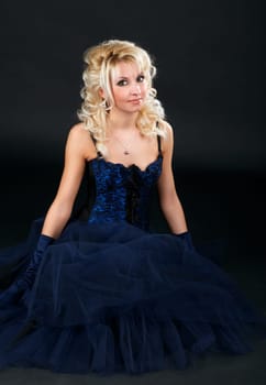 Portrait of a young attractive woman in a blue evening dress.