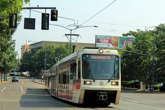 PORTLAND, OREGON - AUGUST 5: Public light rail train travels down a city street on August 5, 2010 in Portland, Oregon. Over 41 million rides were taken on the MAX trains in fiscal year 2011.