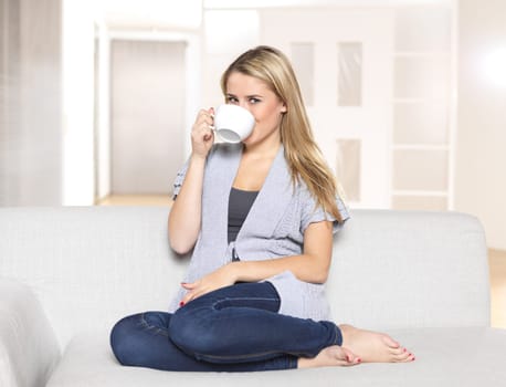 Young woman drinking coffee or tea