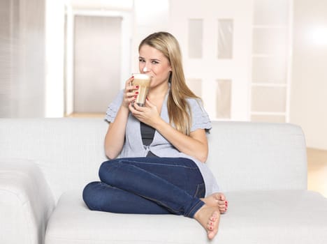 Young woman drinking latte macciato