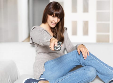 Young woman with remote control