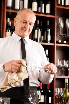 At the bar - waiter clean glass with dish clove restaurant