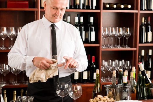 At the bar - waiter clean glass with dish clove restaurant