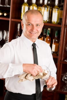 At the bar - waiter clean glass with dish clove restaurant
